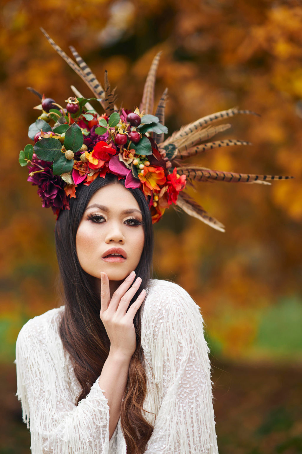 Alternative Christmas Wedding Styled Shoot in reds and golds with large feather headpiece