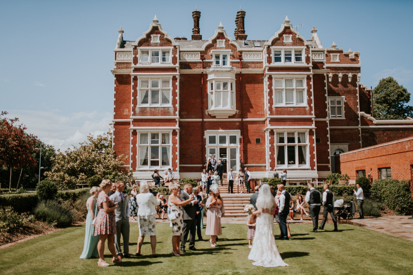 Bride on lawn at Wivenhoe House