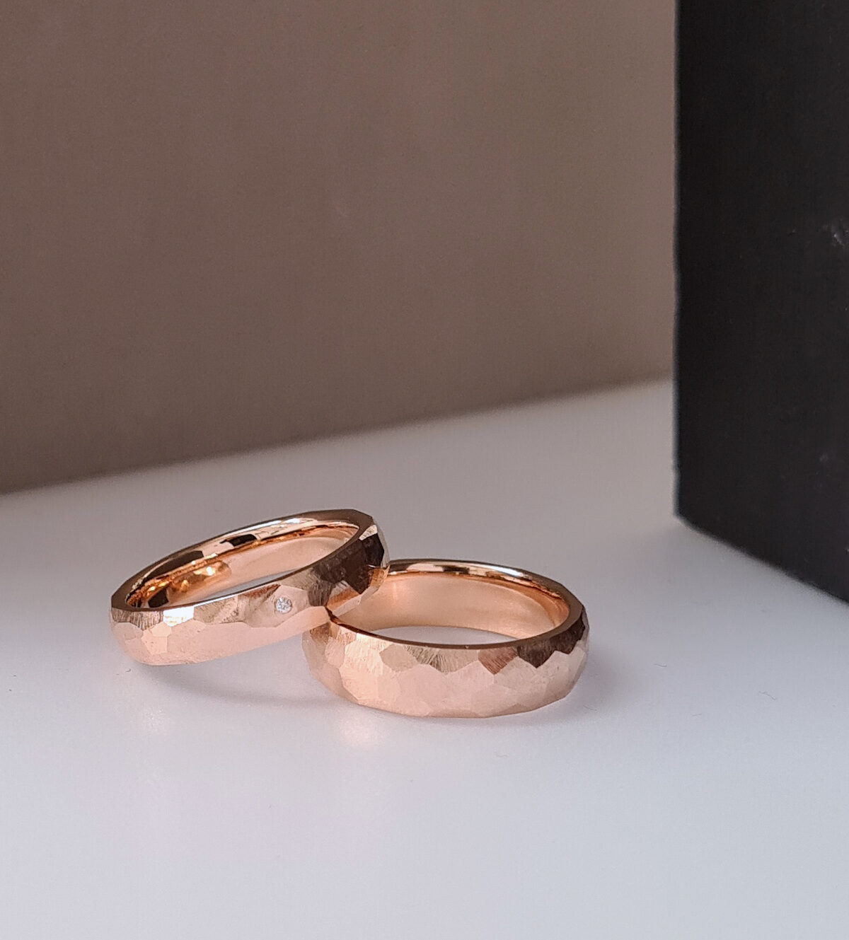 Faceted rings in 18k red Fairtrade gold; one ring with an Australian diamond.