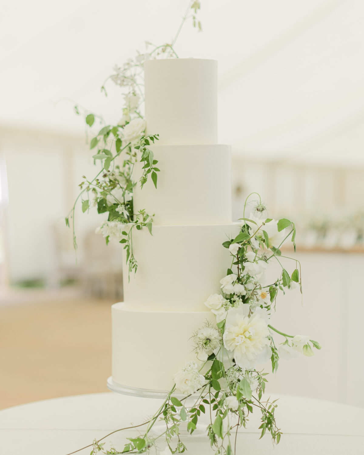 Fresh and floral four tier buttercream cake for Emmy and Milam. Photography by Chloe Winstanley Photography